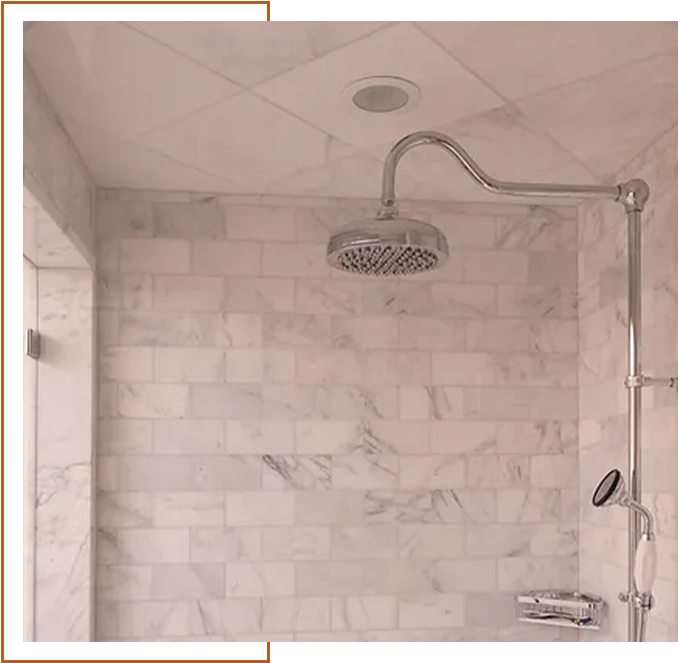 A bathroom with a shower and tiled walls.