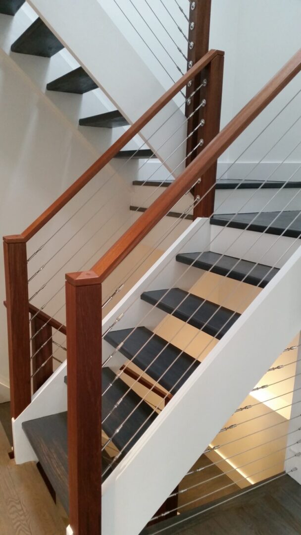 A staircase with wood and metal railing.