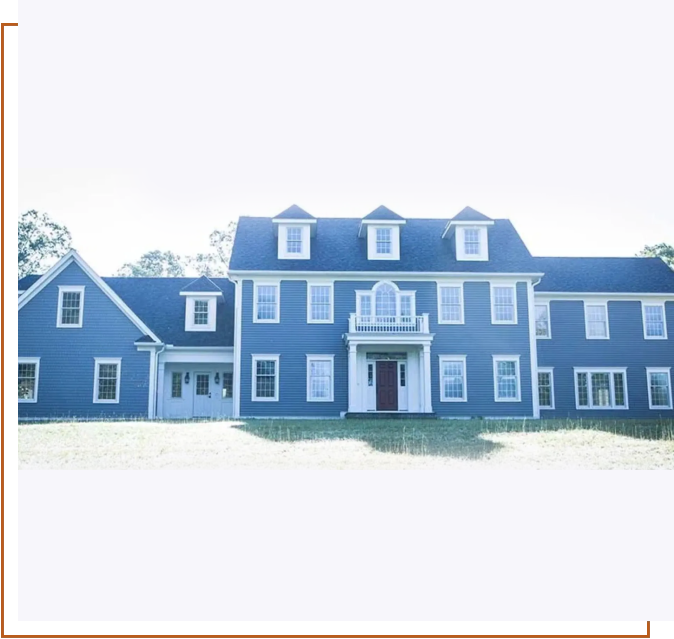 A large blue house with many windows and doors.