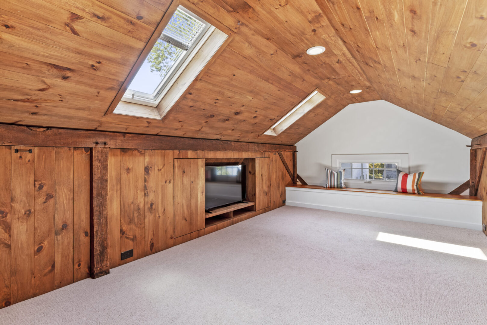 A room with wood paneling and white carpet.